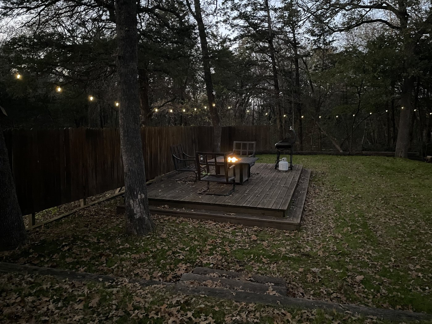 Fire pit at night with string lights